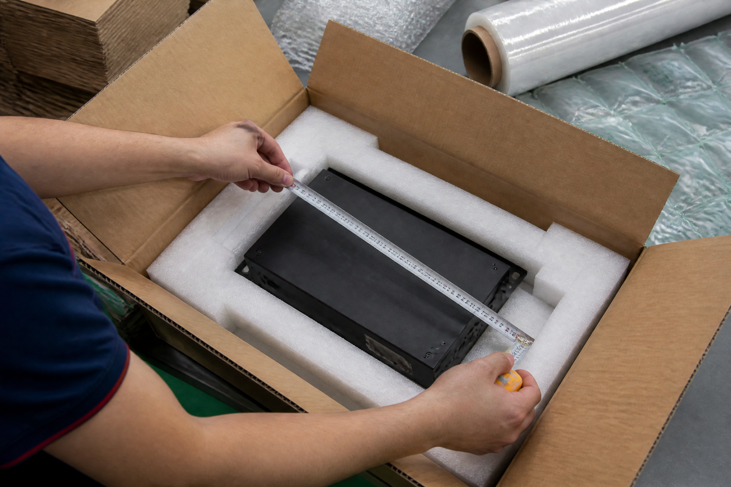 Internal dimension measurement example showing product fit inside corrugated box with cushioning